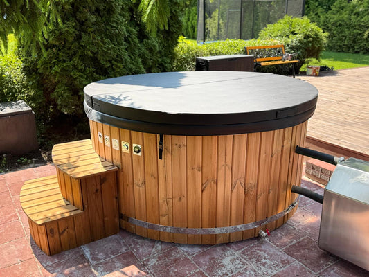 200 cm fiberglass round hot tub with external wood-fired heater, wooden steps and insulated cover, front angle view