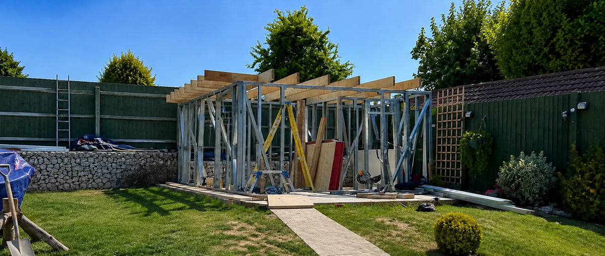 Structural frame going up for Woodera’s first garden sauna during construction in a UK garden.