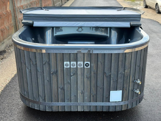 200 x 200 cm square acrylic hot tub with integrated wood-fired heater, front open view with control panel and filter connections